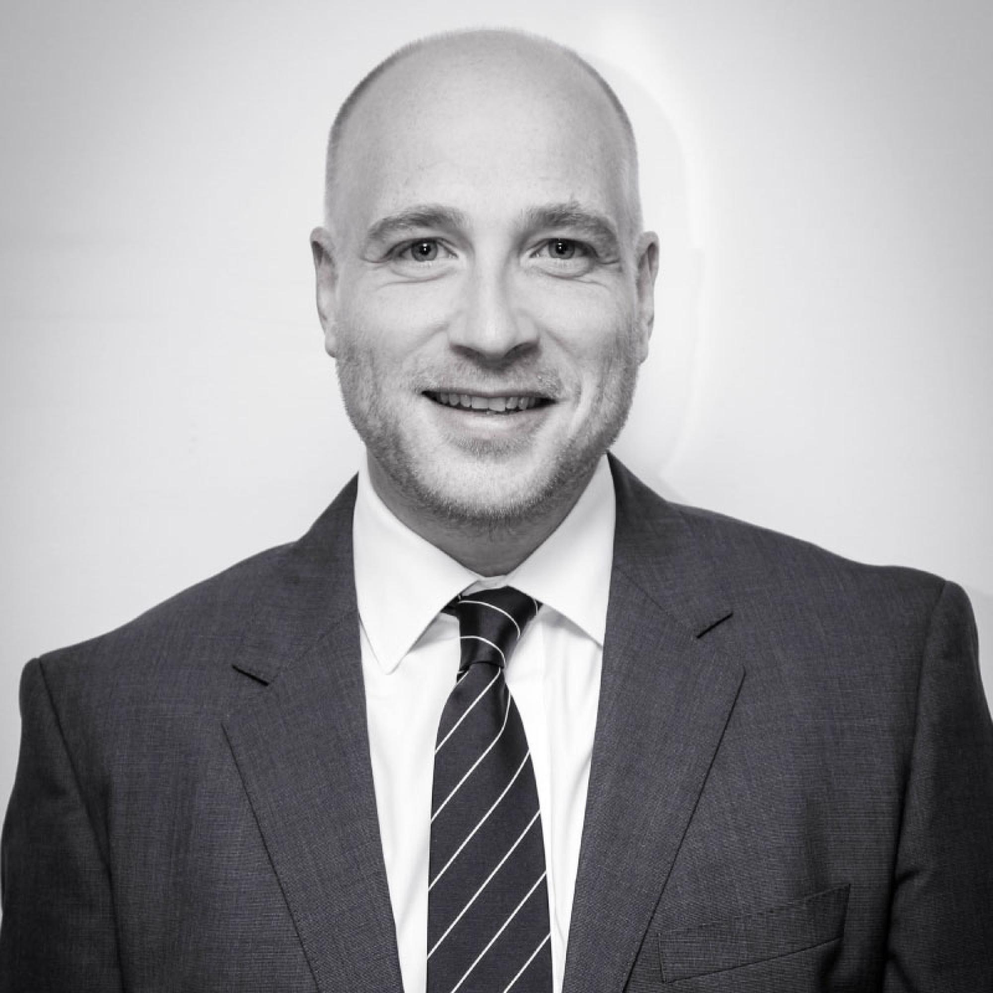 Headshot photo of key contact Phil Branson